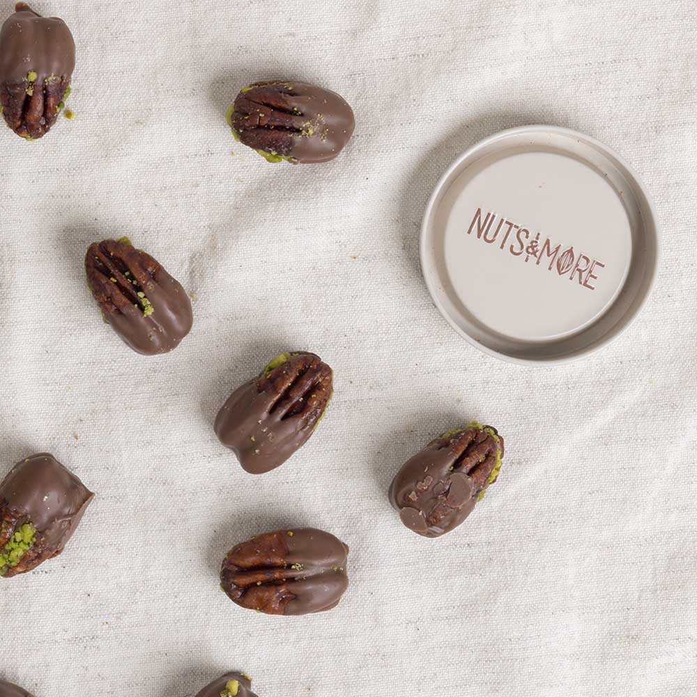 Chocolate Pecan Pistachio Bites in cylinder box